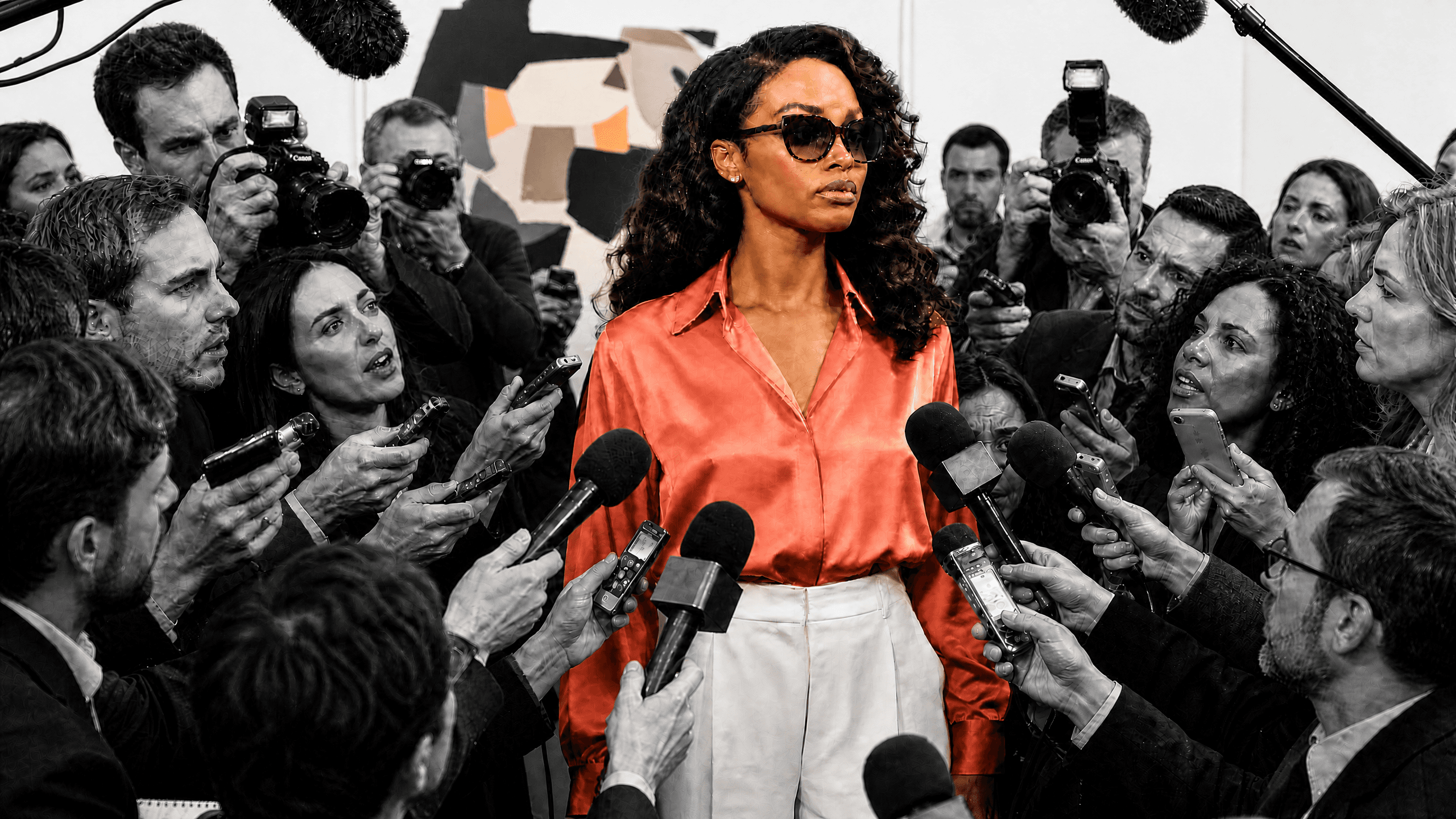 A creator surrounded by press at a public appearance